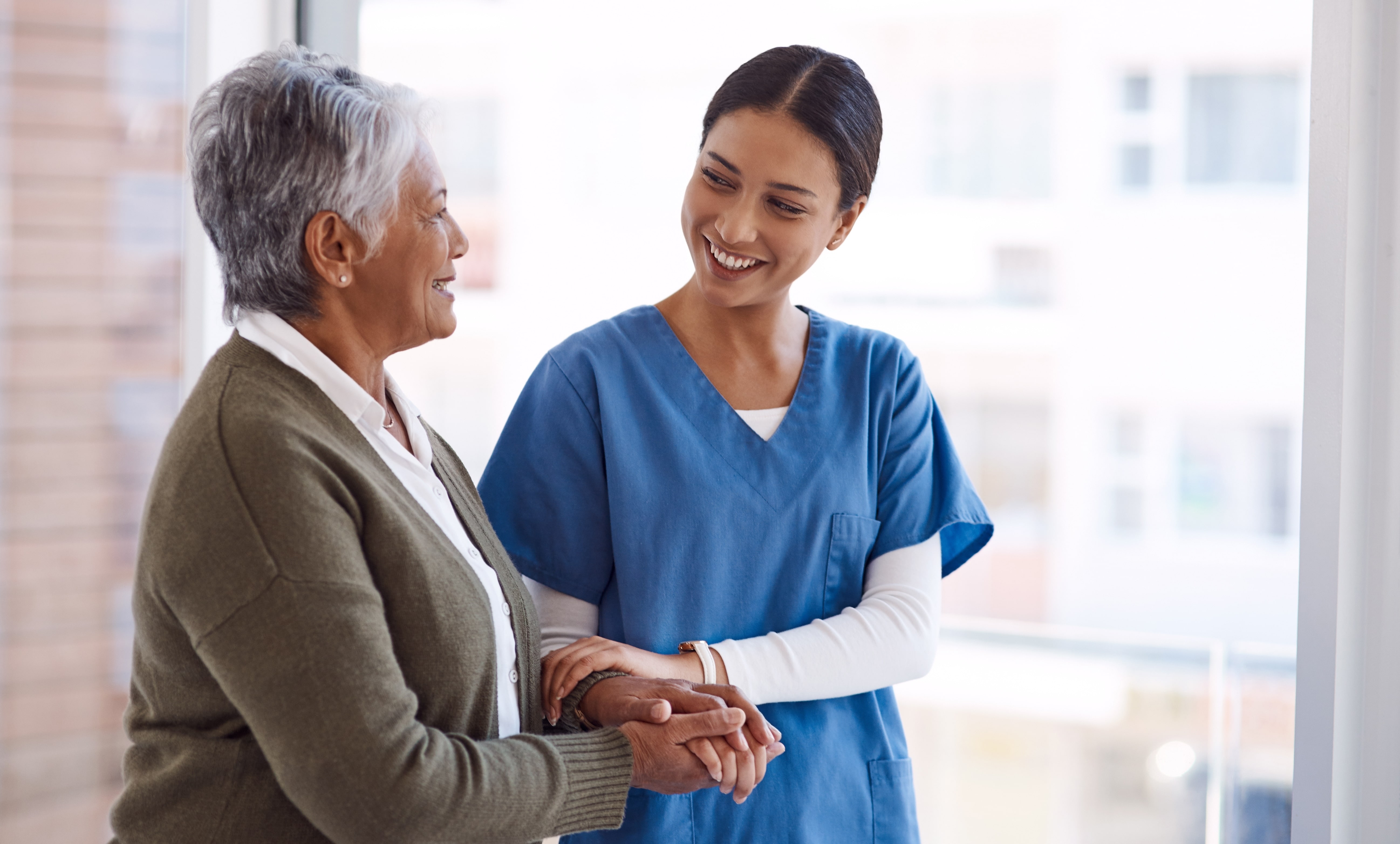 Caregiver helping a senior woman walk