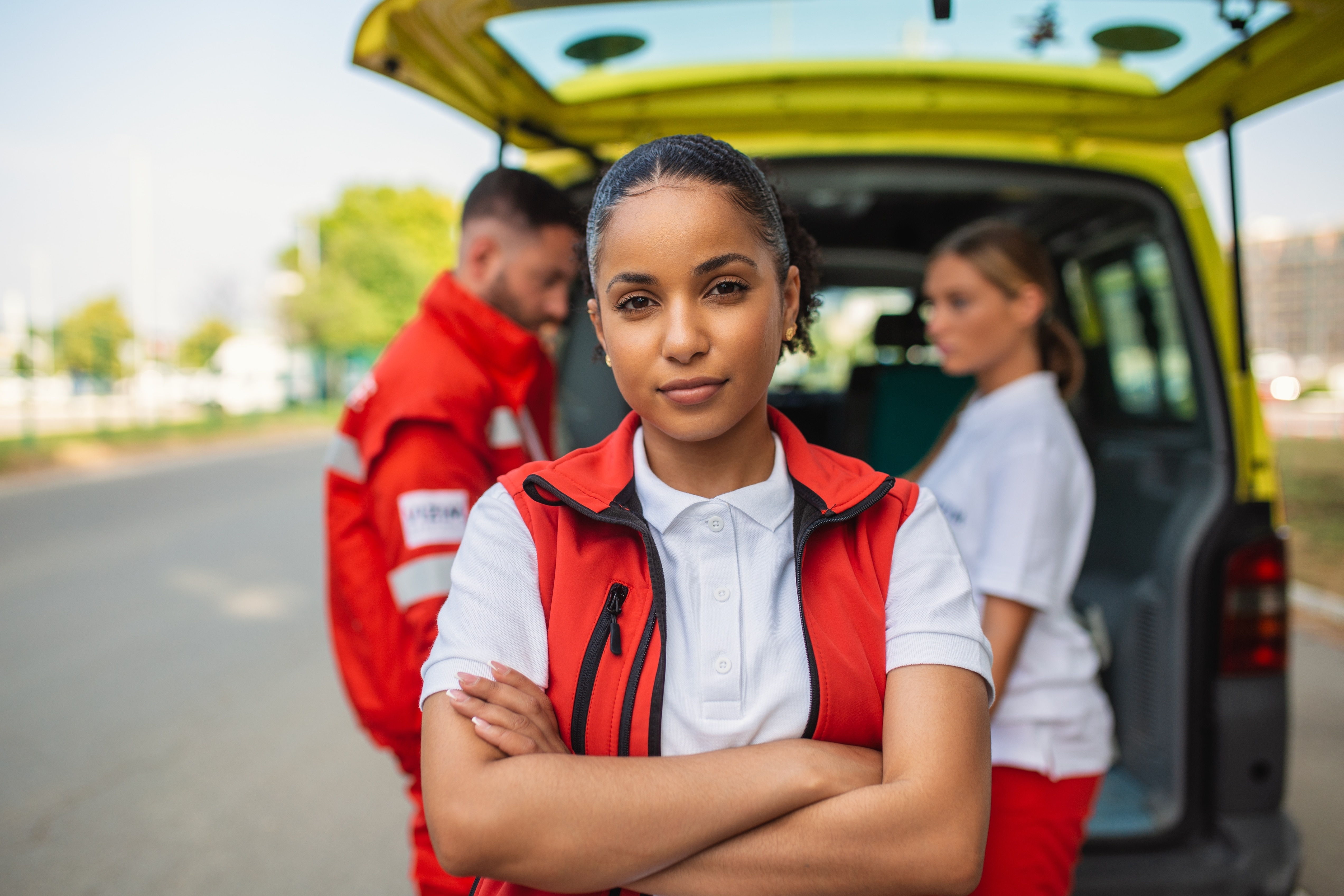 African-American EMS professional standing with her arms crossed