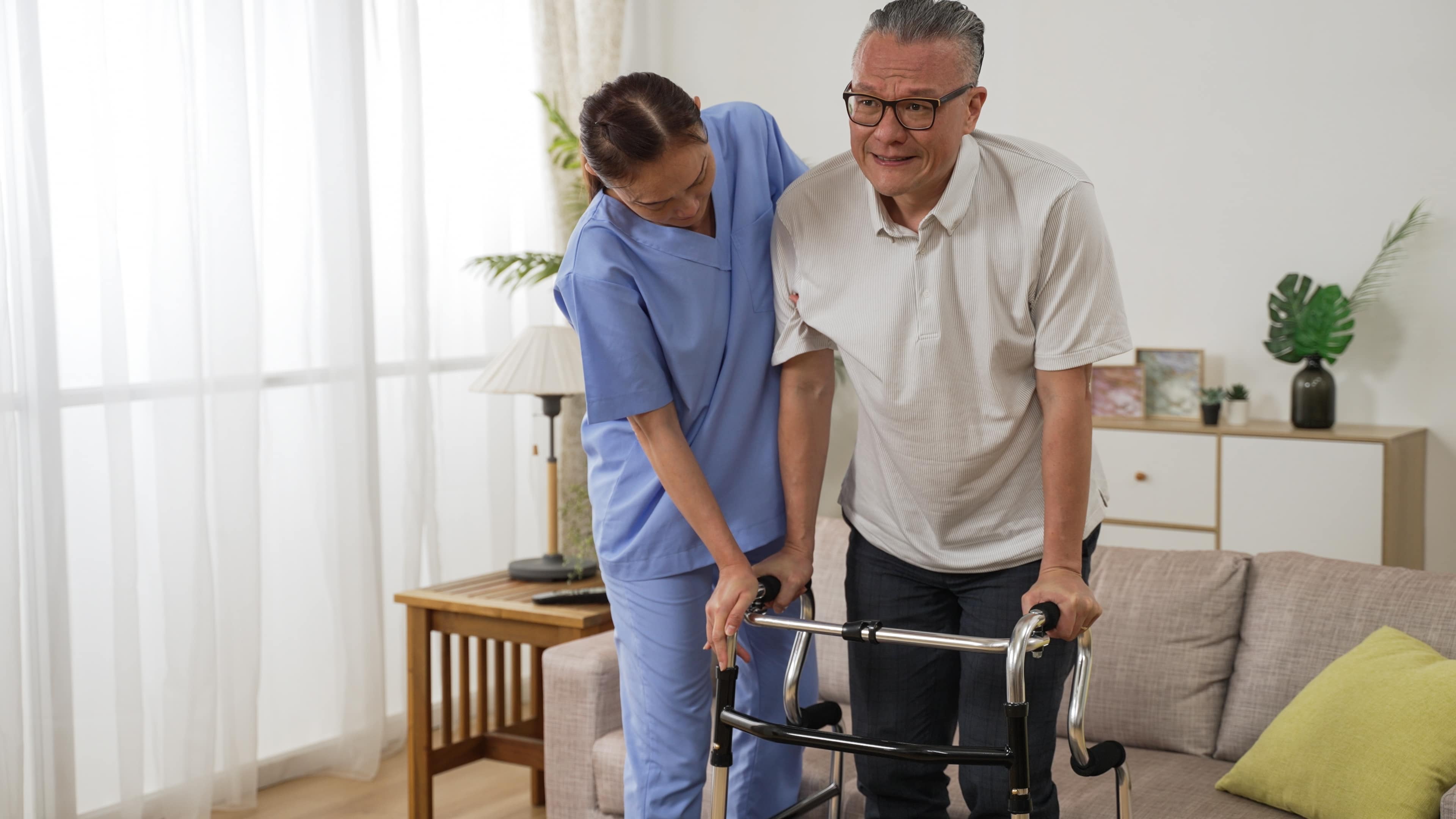 Asian nurse helping a senior stroke victim use a walker