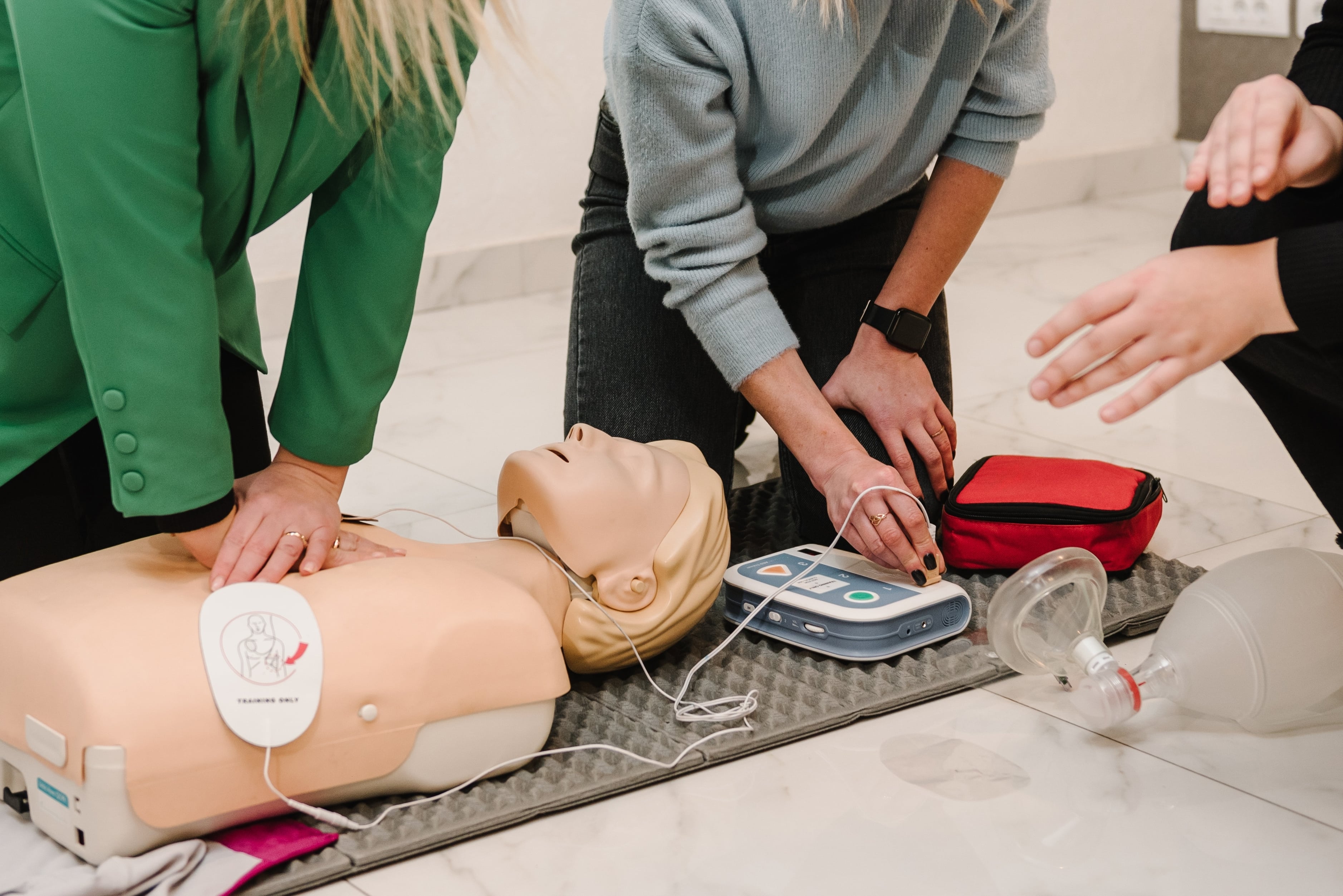Women performing CPR on medical mannequins